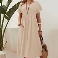 Close-up of a beige pleated cotton linen maxi dress with pockets in a natural setting - 5XL / Dresses / White