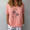 Detail view of loose peach cotton linen top with artistic black dandelion dot print. - Peach