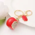 Dettaglio di un portachiavi a forma di mela rossa smaltata con strass scintillanti - Mela (Mela 4)