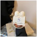 Mini cream white crossbody bag featuring a cute cartoon animal embroidery and large bow detail - Off White