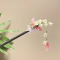 Detail view of a handcrafted wooden hairpin with lily of the valley and silk tassel. - Light Purple Butterfly Lily of the Valley Tassel Style (8143)