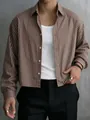 Close-up of men's brown striped long-sleeve shirt with relaxed fit and classic collar. - M / Tops / Coffee