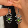 Silver-tone spider earrings with teardrop-shaped green gemstone for Halloween party - Antique Silver Green Gem Style (#6075)