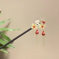 Elegant sandalwood hair stick featuring yellow floral ornaments and red bead tassels - Pale Yellow and White Flower Red Bead Tassel Style (8124)