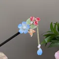 Handcrafted sandalwood hair stick featuring a blue flower and elegant gold chain tassel - Blue Flower Butterfly Tassel Step-Shake Style (2446)