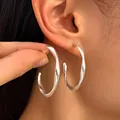 Minimalist matte silver twisted hoop earrings for women, stylish geometric jewelry - Twisted Geometric Style / Matte Silver