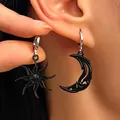 Gothic black sun and moon mismatched drop earrings with intricate cutouts shown on ear. - Matte Black (S129)