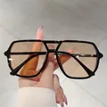 Classic aviator double-bridge sunglasses featuring a sleek black frame and brown gradient lenses. - Black Frame Tea Lens Black Temples