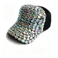 Close-up detail of multi-colored iridescent rhinestones on a black handmade baseball cap - Black