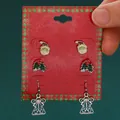 Three-pair festive Christmas earring set featuring Santa Claus, holly, and angel motifs - 3-Pair Santa Claus Set (H-149)
