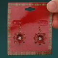 Festive red glitter flower earrings with crystal center on a Christmas display card - Red Poinsettia Flower (A-1139)