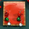 Festive red, green, and silver bell drop earrings displayed on a red Christmas card - Tri-Color Cascading Long Bells (11377)