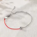 Nahaufnahme eines Glücks-Armbandes mit roter Schnur, Zirkonia und Silberkette. - Strass Armband (A75) / Silber