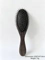 Detailed view of portable air cushion hairbrush with silver needle teeth and wood texture - Silver