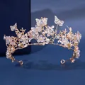 Close-up detail of a gold princess tiara featuring crystal flowers and butterflies - Golden Butterfly Floral Branch Style (HG244)