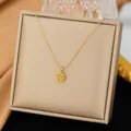 Elegant gold titanium steel camellia flower pendant necklace displayed on a jewelry box - Single Camellia Necklace (Gold)
