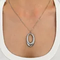 Minimalist silver titanium steel oval ring pendant necklace shown on a model wearing white - Oval Style (WG0-1348) / Silver (Steel)