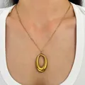 Minimalist gold-plated stainless steel oval pendant necklace displayed on an Asian model. - Oval Style (K-1087) / Titanium Gold