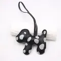 Close-up detail of a handmade black leather dog keychain with grey polka dot pattern - Black Rope Style