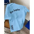 Premium light blue 100% cotton T-shirt featuring a stylish black Gothic Los Angeles chest print - S / Tops / Light Blue (Los Angeles Style)