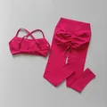 Ensemble de yoga rose vif avec brassière et legging push-up, vue à plat sur fond gris. - S / Haut Et Bas / Framboise