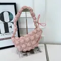 Detailed view of a pink quilted bubble shoulder bag featuring a stylish ruched strap design - Pink