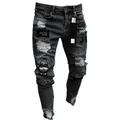 Close-up of distressed details and cartoon patches on dark grey men's jeans. - S / Gray