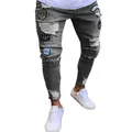 Detail view of men's grey ripped skinny jeans featuring military and peace patches - S / Bottom (805) / Gray