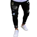 Close-up detail of men's hip hop skinny black ripped jeans with various military patches - S / Bottoms / Black (805)
