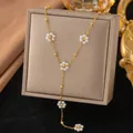 Elegant gold Y-shaped necklace with pearl flower accents on a jewelry box. - Five Artificial Pearl Flowers (H1177)