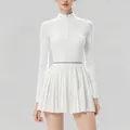 Detailed view of a white women's long-sleeve pleated tennis dress featuring a half-zip neckline - XS / Long-sleeved Top And Bottom / White