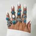 Bohemian vintage silver ring set with turquoise and white stones displayed on a hand. - 11-Piece Set (33321-ring-blue)