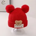 Red knitted baby winter hat featuring a cute bear patch and fluffy double pom-poms - One Size / LUCK Bear Double Pom / Red