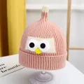 Cute pink knitted baby winter hat featuring cartoon eyes and yellow pom-pom accent - One Size / Angry Birds Style / Pink