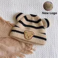Striped knit baby beanie with cute bear ears and patch in beige and black. - One Size / Striped Bear Kids / Beige
