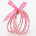 Elegante set di 5 bracciali in silicone con glitter rosa e fiocco in nastro di raso rosa - Confezione da 5 / Rosa