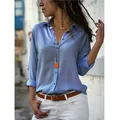 Detailed shot of a casual light blue long-sleeved button-up shirt with V-neck detail - S / Tops / Denim Blue