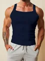 Close-up detail of men's navy blue ribbed gym tank top featuring a tight muscle fit - S / Tops / Navy Blue