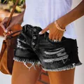 Gros plan sur un short en jean noir déchiré pour femme avec ourlet effiloché et boutons - S / Bas / Noir