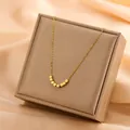 Close-up of a gold stainless steel necklace with cube pendants on a jewelry box - Fortune Square Cube Necklace (8412)