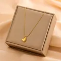 Close-up of minimalist 18k gold plated heart pendant necklace on display box - Solid Heart Pendant (8456)