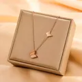 Rose gold titanium steel necklace featuring frosted butterfly pendant displayed on gift box - Double Butterfly Style (825) / Rose Gold