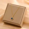 Gold-plated titanium steel necklace with black four-leaf clover pendant on jewelry box - Double-sided Clover (T0124)