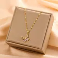 Elegant 18k gold plated titanium steel butterfly pendant necklace on a beige jewelry box - Butterfly Rhinestone Inlaid Necklace (T0264)