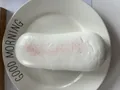Detailed view of realistic PU simulation bread squishy toy on a white plate. - Croissant / White