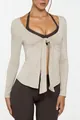 Macro view of front-tie design on beige long-sleeve yoga top for fitness wear - S / Tops / Milky Apricot