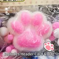 Detailed close-up of a pink and white flocked cat paw squeeze toy for stress relief - White