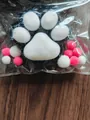 Soft flocked cat paw squishy stress relief toy with decorative pink and white pom poms - Black