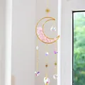 Atrapasol de luna con cristales y piedras naturales rosas junto a una ventana soleada - Citrino