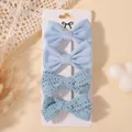 Set of four light blue bow-shaped fabric hair clips for children on white display card - Set of 4 / Light Blue